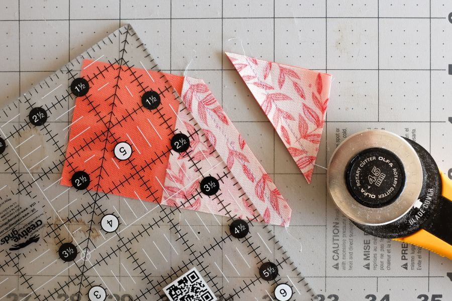 a square piece of fabric cut by a rotary cutter diagonally